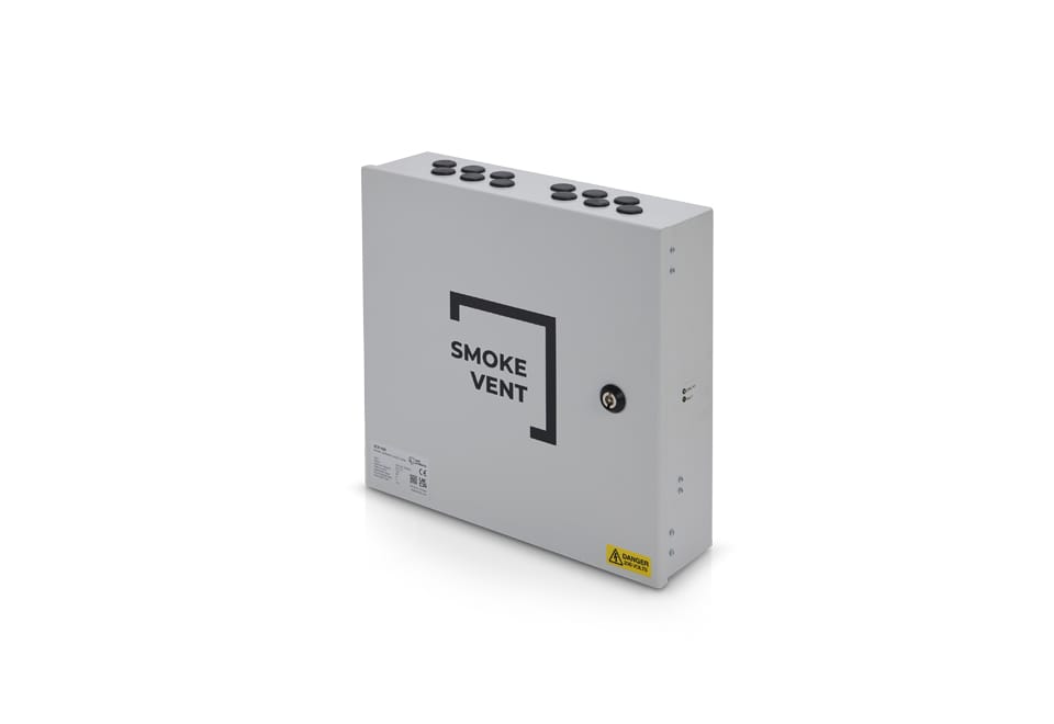 A gray rectangular smoke vent control box with multiple cable entry points on the top and a lockable access panel on the front labeled "SMOKE VENT" integrates seamlessly into natural ventilation systems, efficiently managing window actuators.