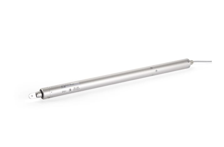 A cylindrical metallic sensor with a wire extending from one end, featuring various labels and certifications etched on the surface, ideal for integration into door automation systems.