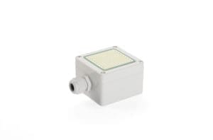 A small, square, gray electronic device with a flat, ridged surface on top and a connector port on one side, perfect for integrating into window actuators to enhance natural ventilation.