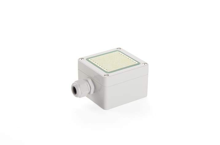 A small, square, gray electronic device with a flat, ridged surface on top and a connector port on one side, perfect for integrating into window actuators to enhance natural ventilation.