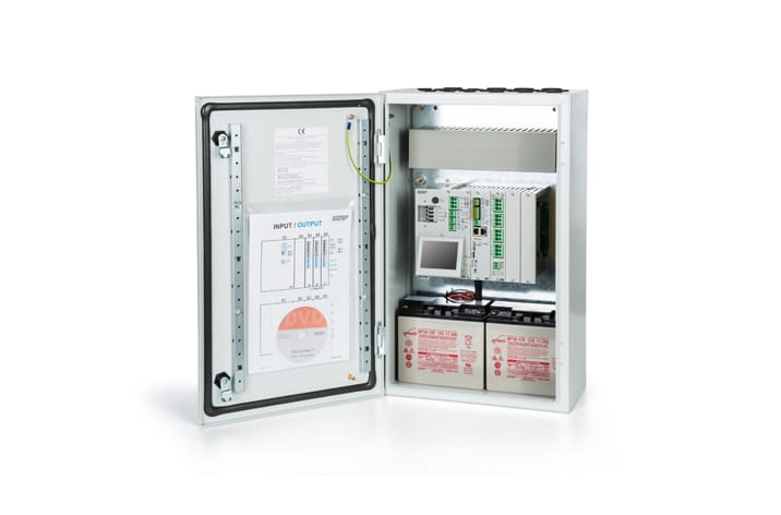 An open electrical control panel displaying circuits, wiring, window actuators, and two batteries.